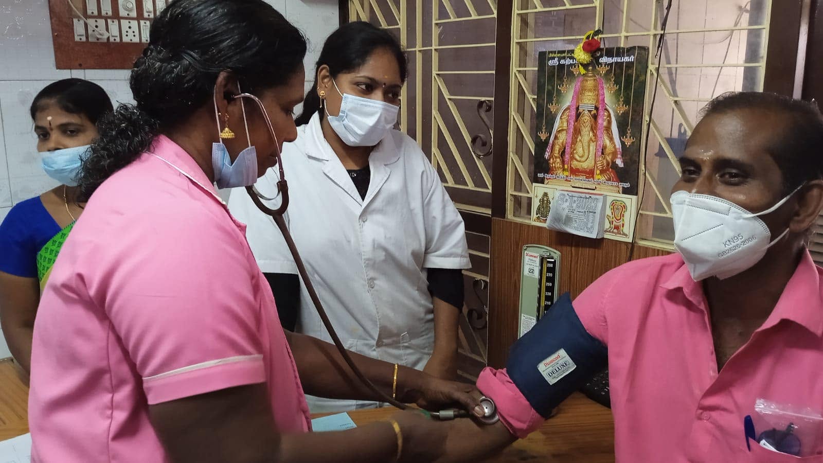 Nurse checking blood pressure of a hospital staff member during a routine health check-up at Kannan Nursing Home, Chidambaram.